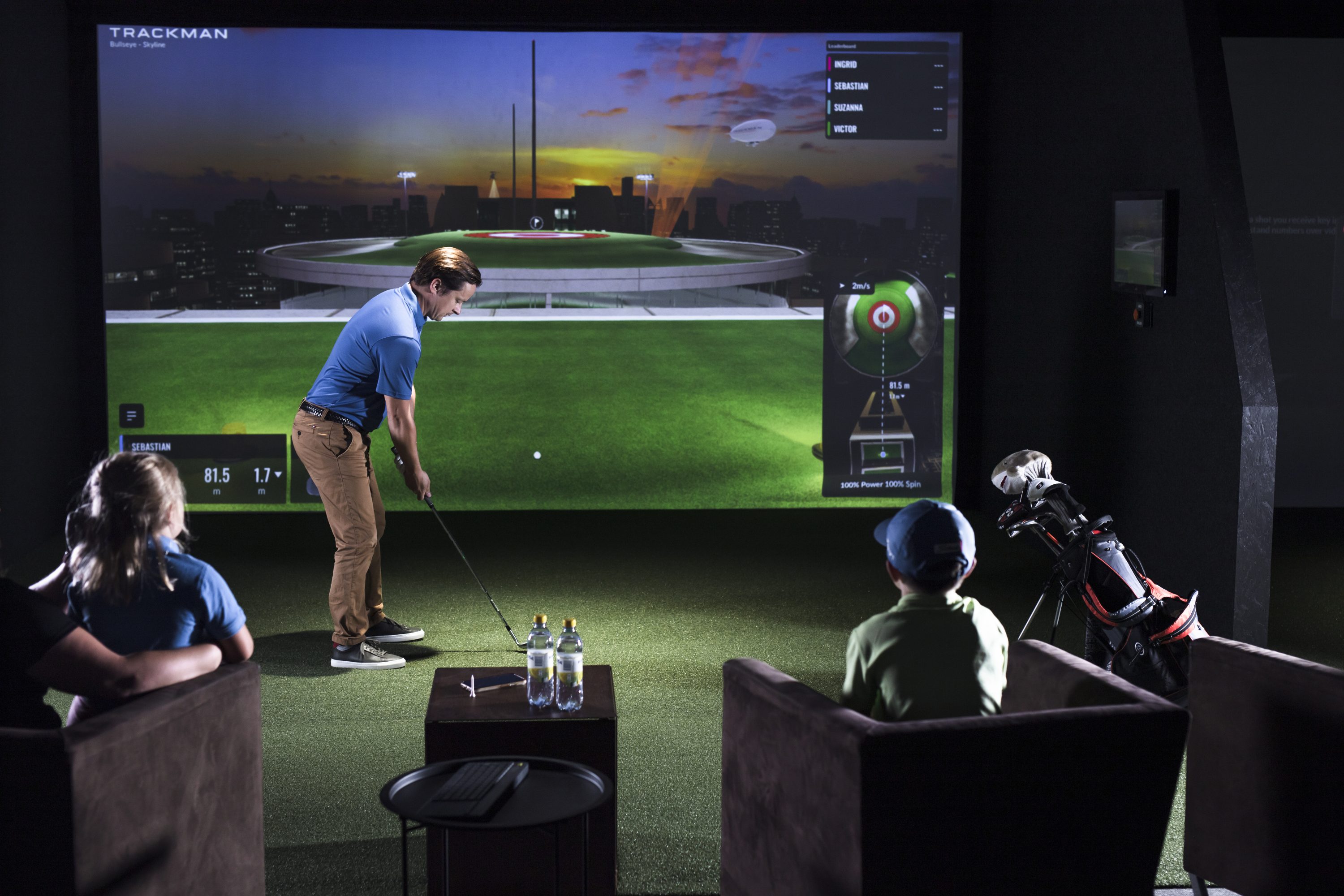 a family playing bullseye at the golf simulator.